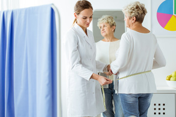 Dietician measuring patient's body circuit