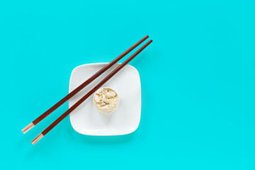 Protein powder in scoop on small plate with chopsticks