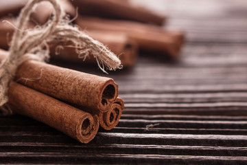 Cinnamon essential oil on a wooden background