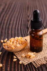 Fototapeta na wymiar frankincense essential oil on a wooden background