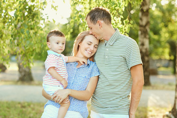 Fototapeta premium Happy family in nature. Parents with a child play in park.