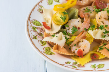 Shrimp veggie colorful bowtie pasta.
