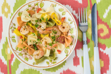 Shrimp veggie colorful bowtie pasta.