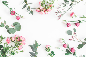 Flowers composition. Frame made of various pink flowers and eucalyptus branches on white background. Flat lay, top view, copy space