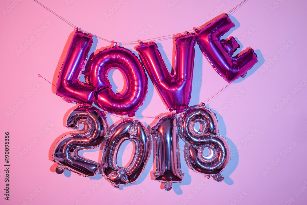 Wall mural balloons forming the word love and the number 2018