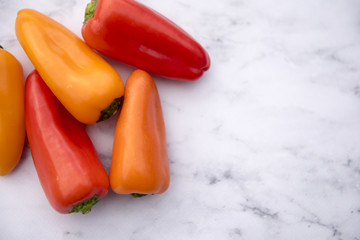 Colourful sweet pepper on a marble background with copy space