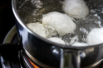 Fototapeta na wymiar eggs boiling in pan of water