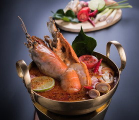 Spicy soup with shrimp in bowl , famous Thai food cuisine calling Tom Yum Kung
