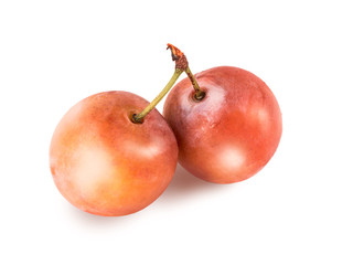 Two cherry plums with green tail, closeup, isolated on white background. Retouched ripe berries of plum