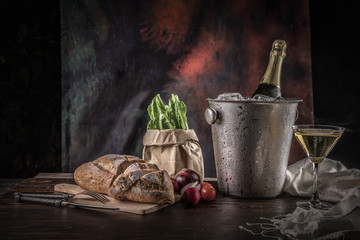 Champagne in the glass with bread and vegetables.