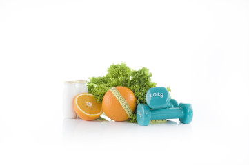 summer set for diet. Proteins shake, oranges, dumbbells and lettuce. Sport and diet
