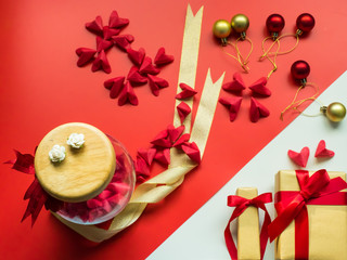 flat lay minimal concept for valentine's day and chinese new year event with lot of heart (origami)in beauty jar with gift box  on red background