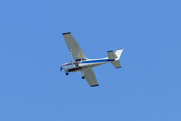 Fototapeta na wymiar Single engined light aircraft flying a clear blue sky