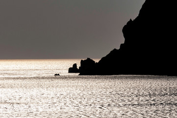 rocky silhouette in sea