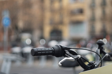 Handlebars of bicycle parked on street