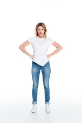 Fototapeta premium attractive woman standing akimbo isolated on white