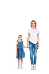 smiling mom and daughter holding hands, isolated on white