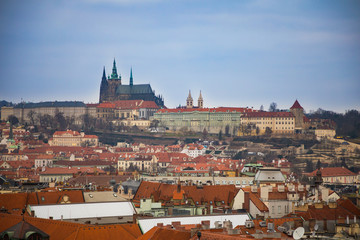 Fototapeta premium View of Prague castle and red roofs of old town in evening time, Czech Republic
