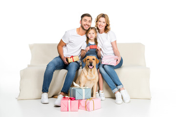 happy family and dog sitting on sofa with gifts, isolated on white