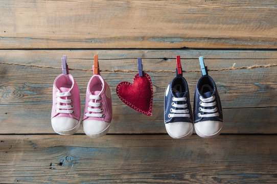 Baby shoes hanging on the clothesline.