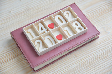 Wooden block calendar show date, month and year with Two Red hearts.