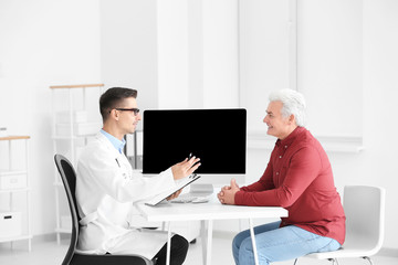 Male doctor consulting patient in clinic