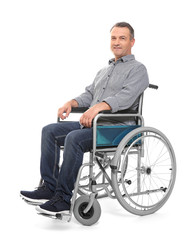 Mature man in wheelchair on white background