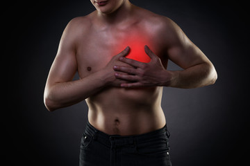 Heart attack, man with chest pain on black background