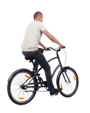 back view of a man with a bicycle.