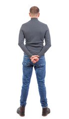 Back view of man in jeans. Standing young guy. Rear view people collection.  backside view of person.  Isolated over white background. Shorthaired man in a dark jacket as an observer