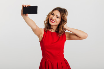 Fototapeta premium Portrait of a beautiful young woman dressed in red dress