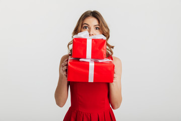 Portrait of a surprised young woman dressed in red dress