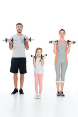 sportive parents and daughter with dumbbells isolated on white