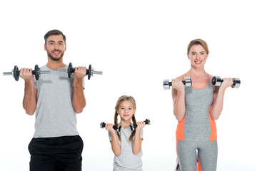 Fototapeta na wymiar portrait of sportive parents and daughter with dumbbells isolated on white