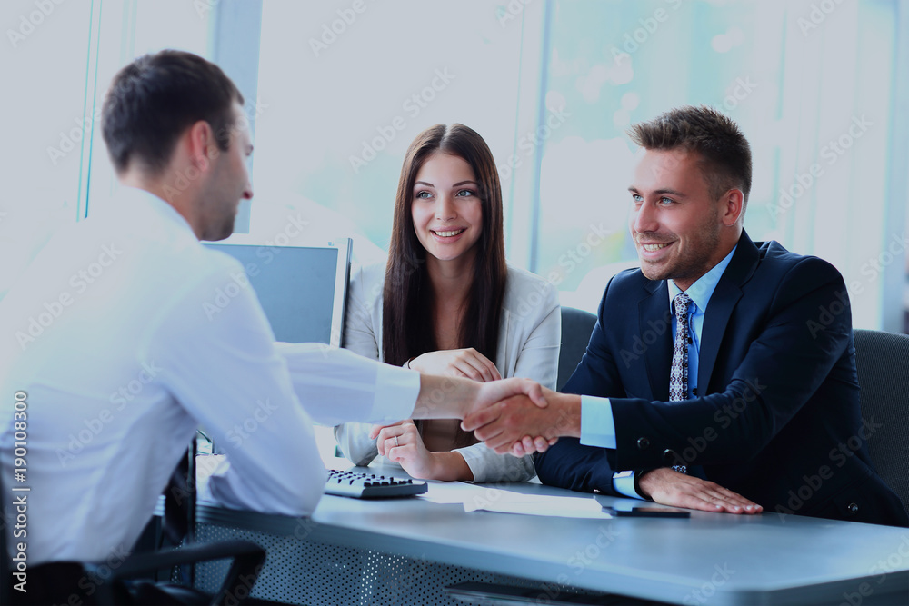 Wall mural businessman shaking hands to seal a deal with his partner.