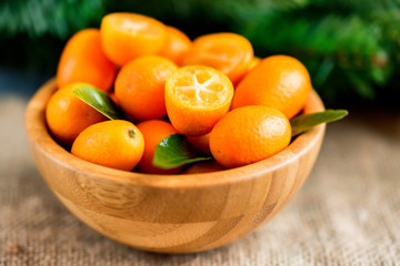 Kumquat or cumquat on wooden table