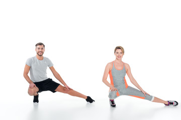 Fototapeta premium sportive couple warming up before training isolated on white