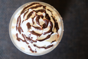 Drink covered with whipped cream and chocolate sauce