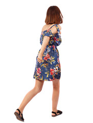 back view of running  woman. beautiful girl in motion. backside view of person.  Rear view people collection. Isolated over white background. The girl in a colorful dress runs to the side