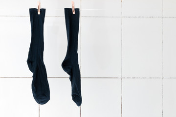 Men's socks weigh in the bathroom on the rope to dry. Socks for every day of the week