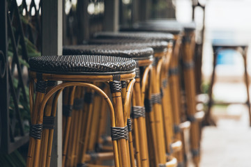 Wooden bar stools in a row. Street restaurant