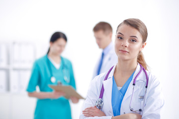 Attractive female doctor in front of medical group.