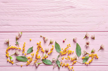 Beautiful flowers on wooden background