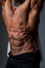 Fototapeta na wymiar Muscular torso of sexy young male bodybuilder power