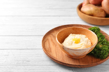 Bowl with mashed potatoes on table