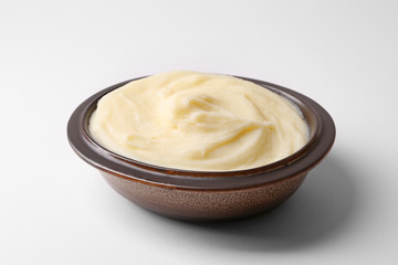 Bowl with mashed potatoes on white background