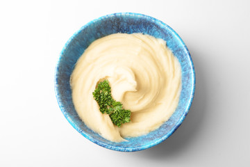 Plate with mashed potatoes on white background
