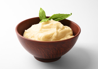 Bowl with mashed potatoes on white background