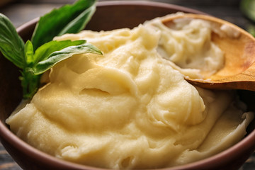 Mashed potatoes and spoon in bowl, closeup