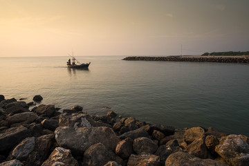 The fisherman is going back from the sea in the morning